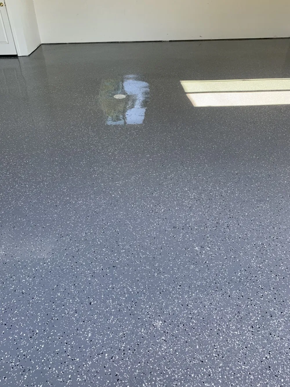 Full-broadcast flake floor coating with a high-gloss sealed finish in a Denver garage
