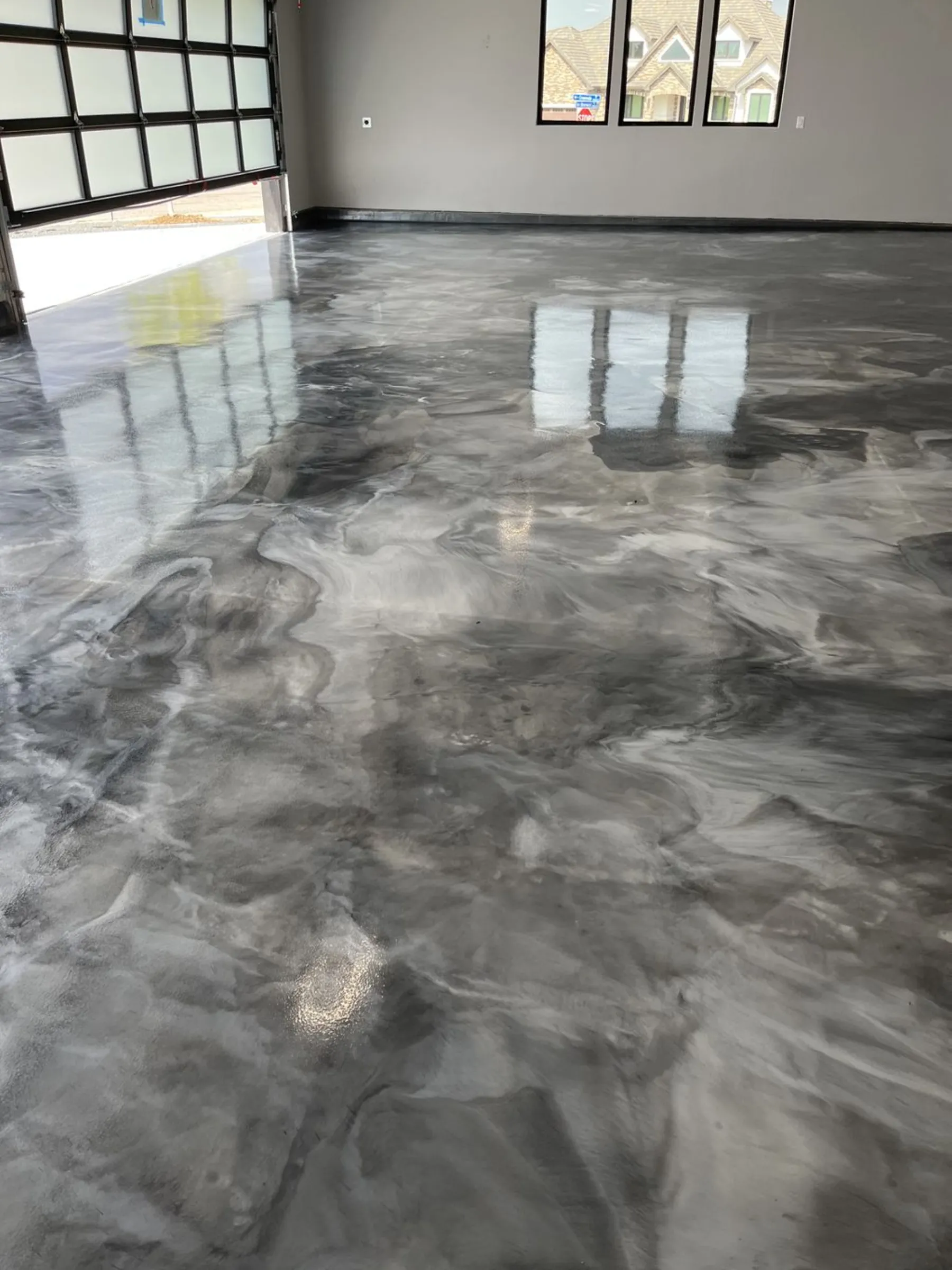 High-gloss metallic epoxy floor installed in a Denver garage