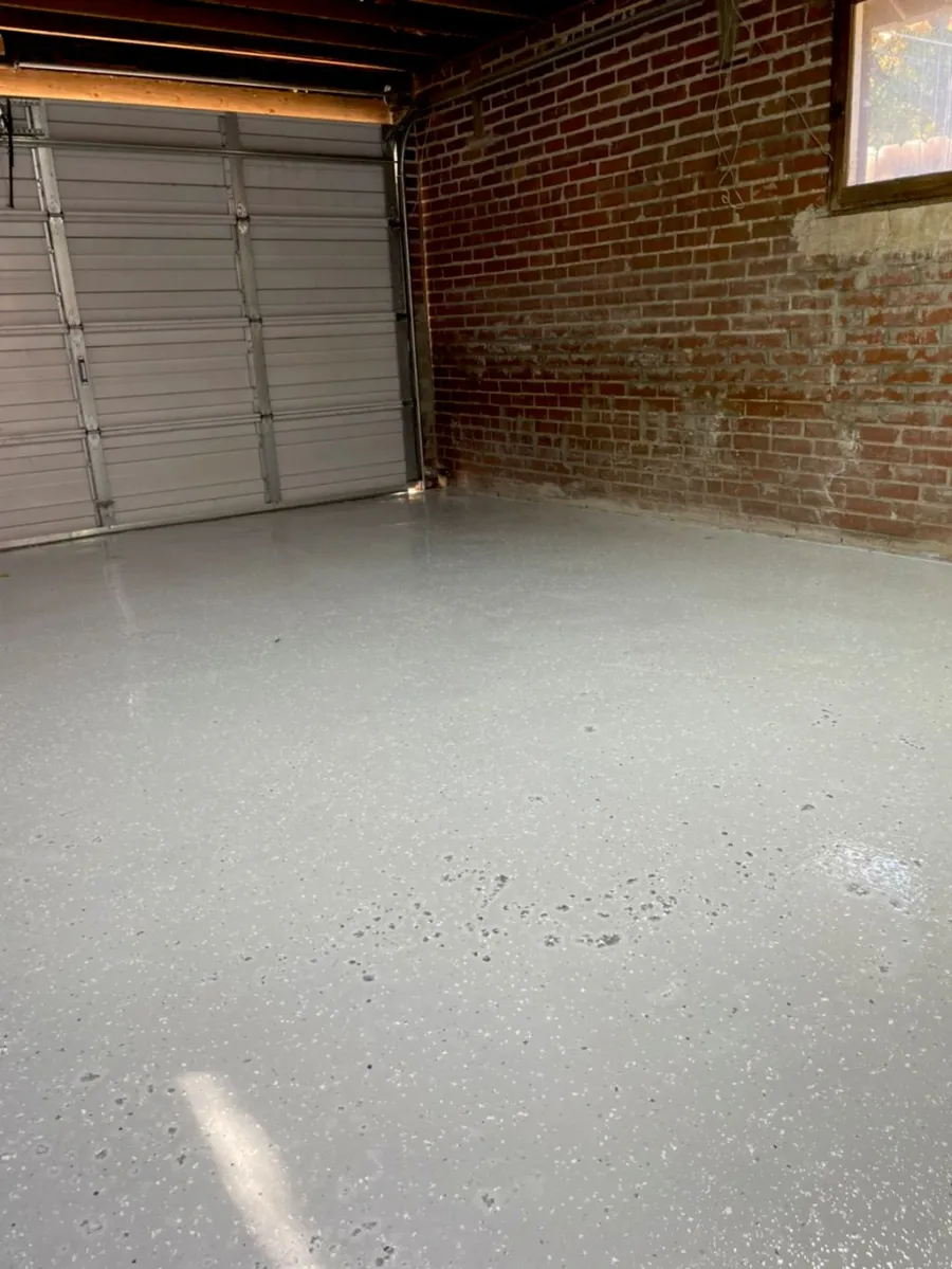 Coated garage floor in a brick-walled Denver garage